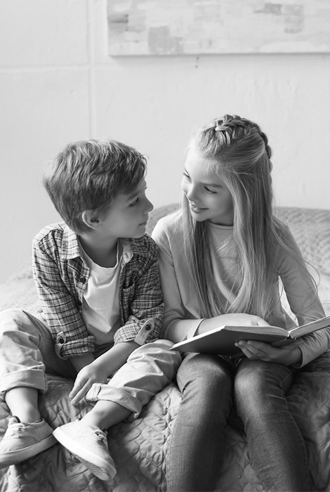 Boy and girl reading a book