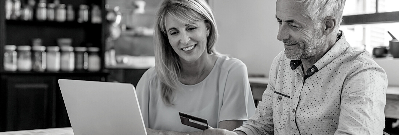 Couple at home on computer doing their banking.