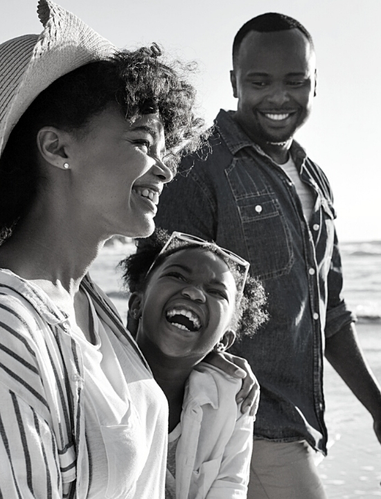 African American Family at the beach smiling and having fun