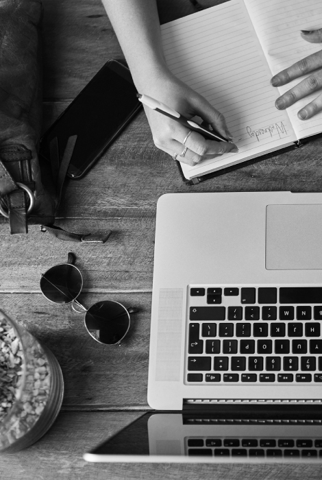 Top down view of woman writing at computer desk