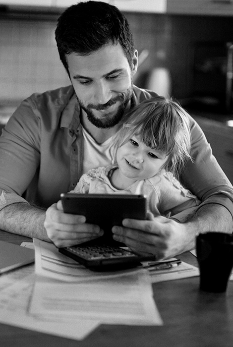 Dad and daughter on tablet looking over finances