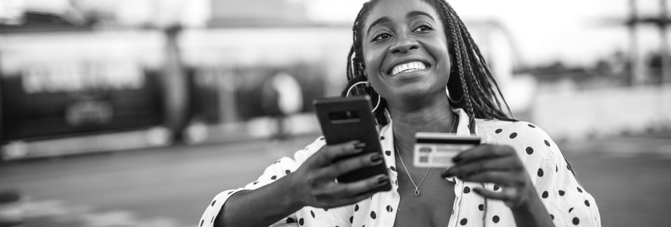 Woman using mobile banking with debit card and smart phone