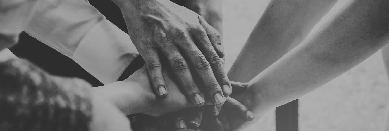 Group of people with hands stacked