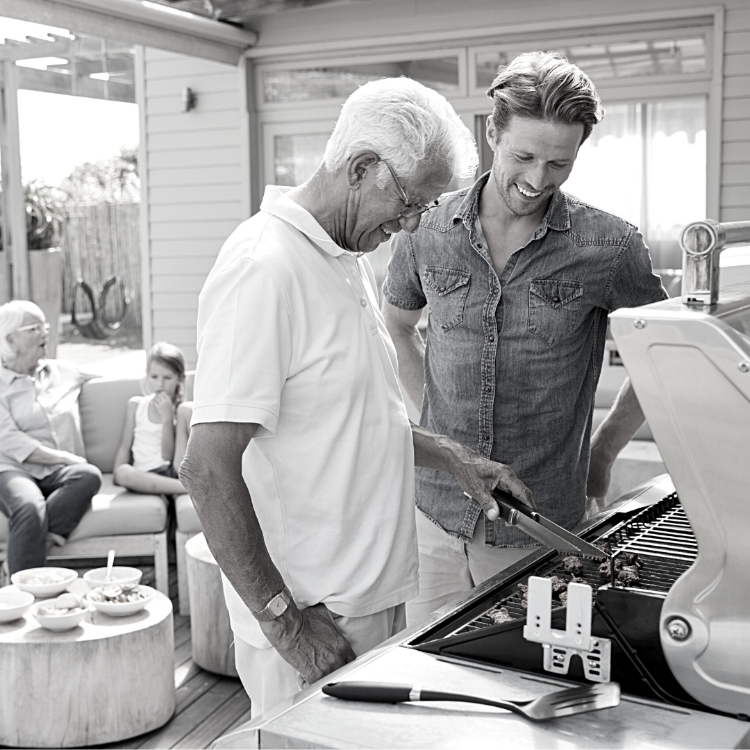 father and son outside grilling