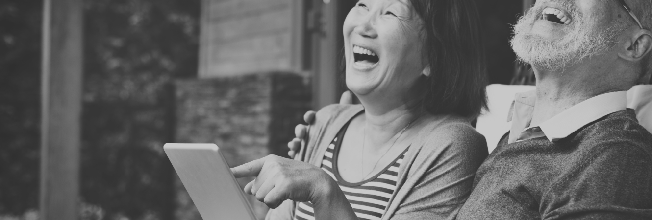 A happy, mature couple with a tablet device