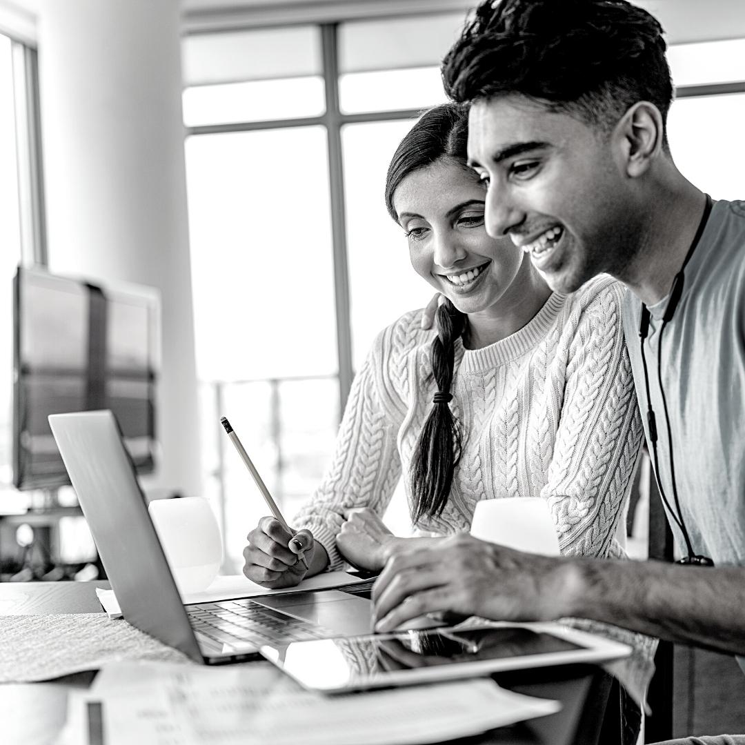 young couple on laptop budgeting together