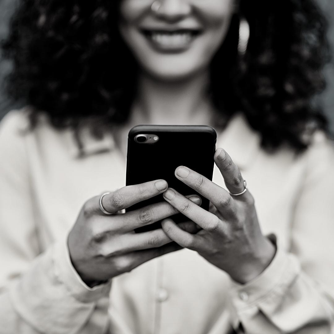 woman holding cell phone