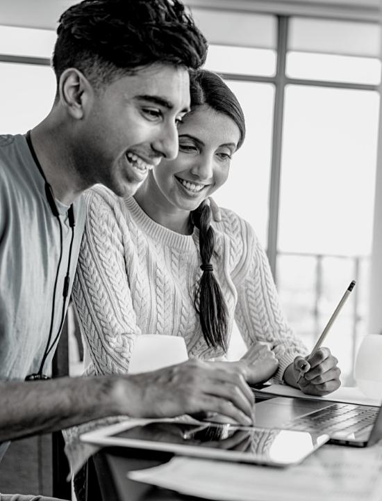 young couple on laptop budgeting