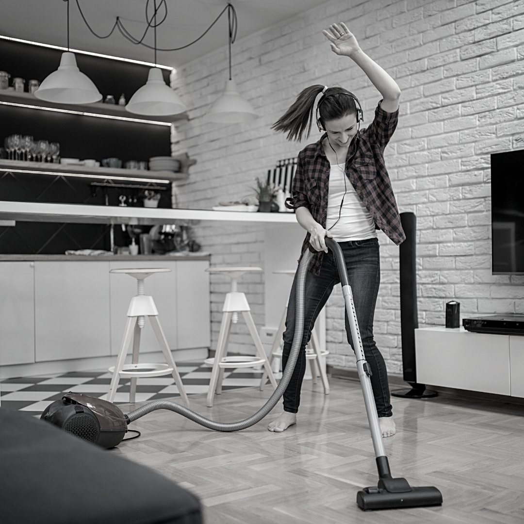 woman vacuuming with headphones on
