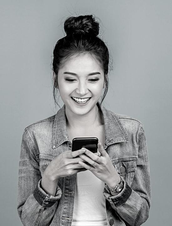 young woman holding cell phone