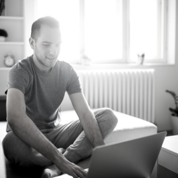 White male at home on laptop