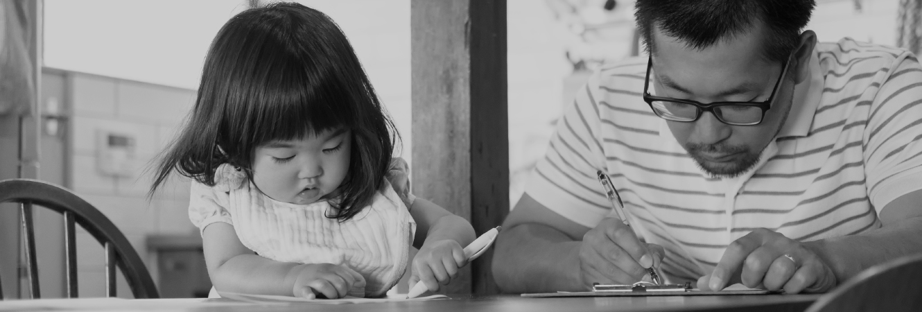 Father and daughter at a kitchen table