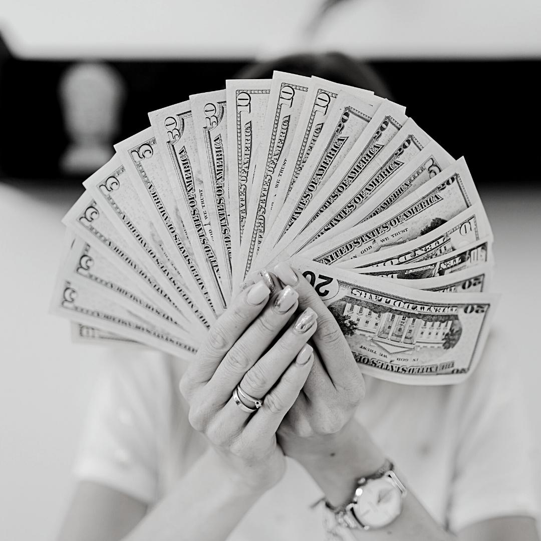 women's hands holding cash