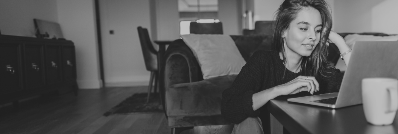 A girl on her laptop sitting in living room