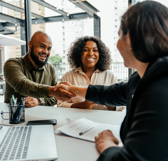 couple shaking hands with lender