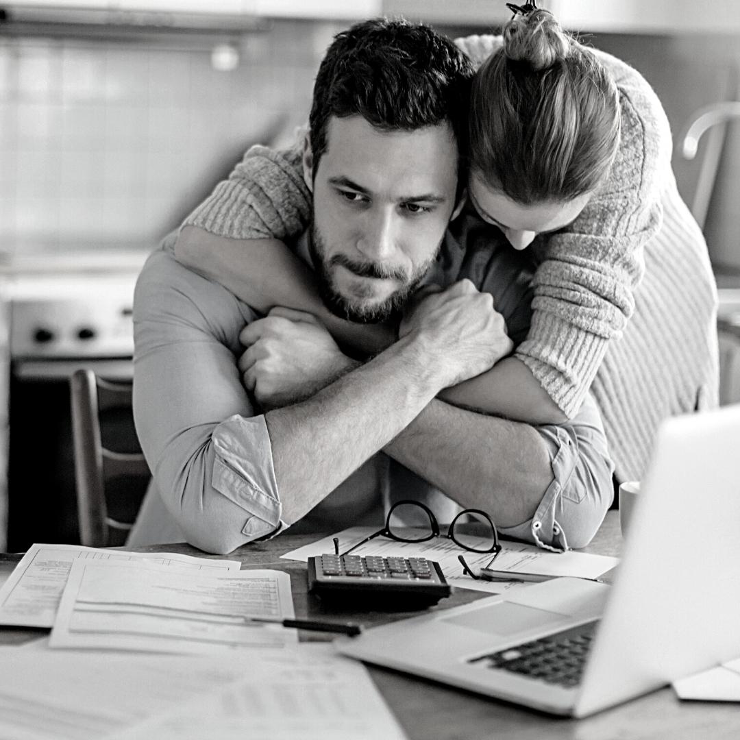 couple budgeting and looking worried