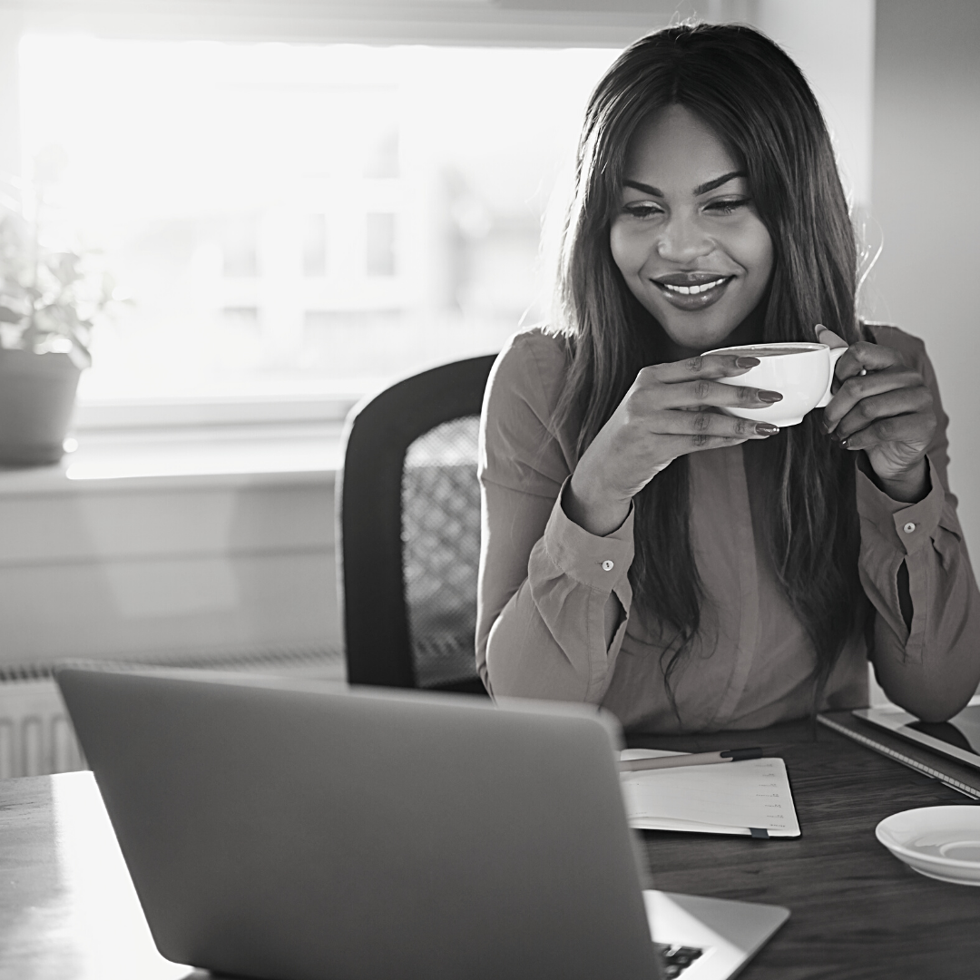 lady working from home with laptop and coffee in hand