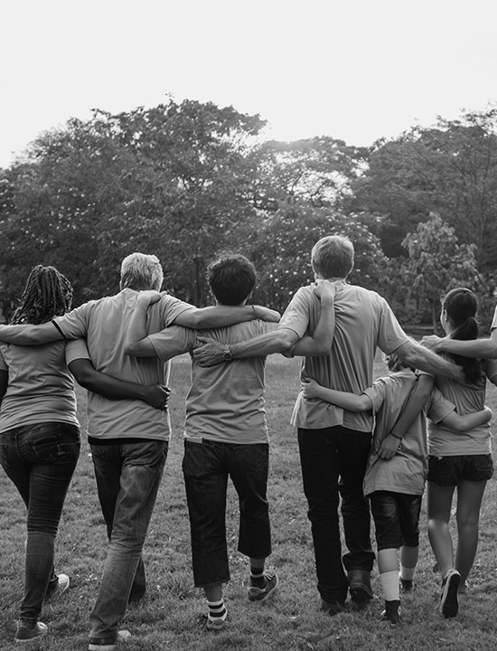 Community walking with arms around eachother