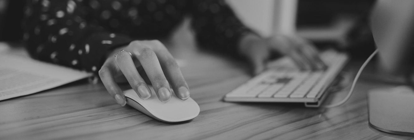 Close up shot of hands on a keyboard and mouse