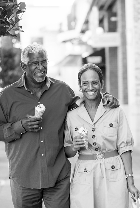 Older couple walking and enjoying ice cream.