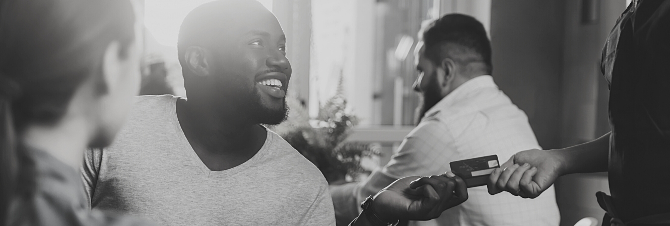 African American Man Paying with debit card at a restaurant