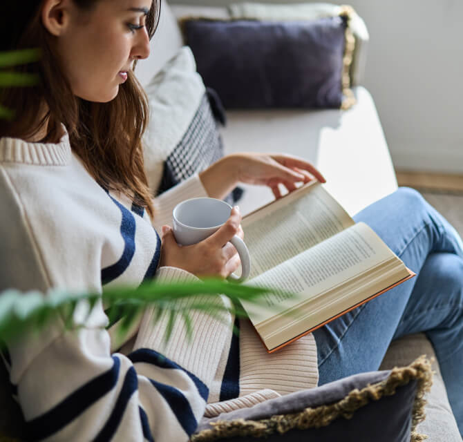 woman reading on couch
