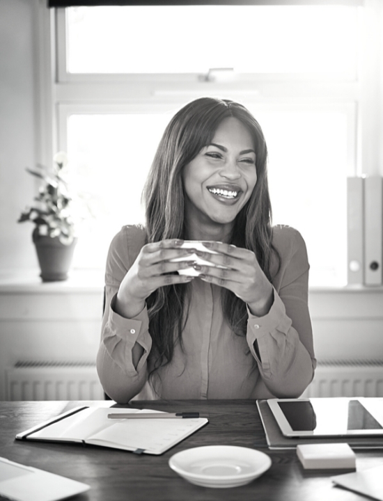 Woman smiling holding coffee cup